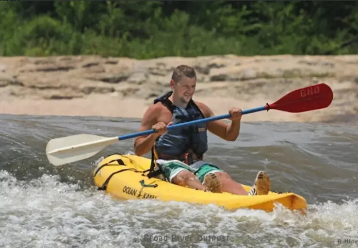 A kayaker on broad river.