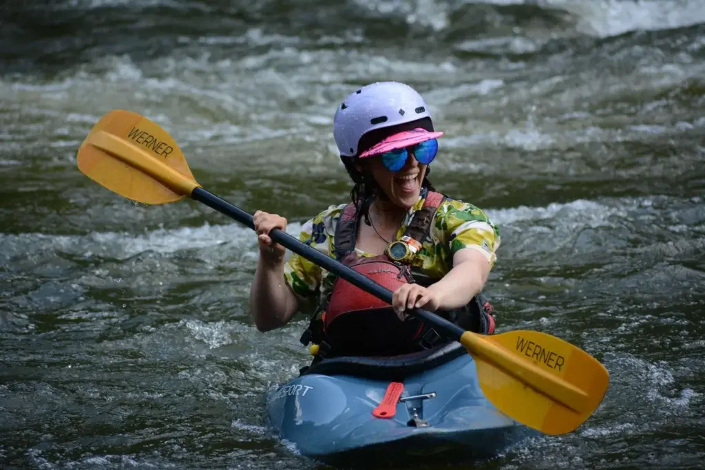 Girl smiling and Kayaking.