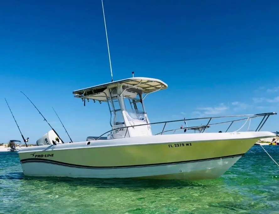 A small center console fishing boat anchored in the ocean.