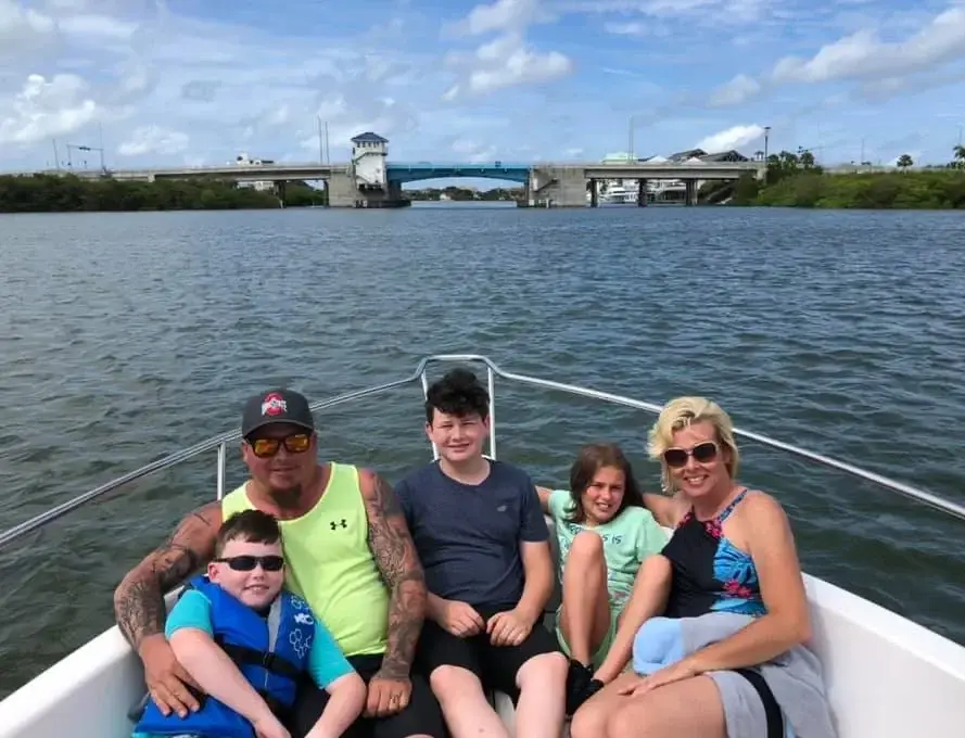 A family poses on the bow of a boat in Madeira Beach, Florida.
