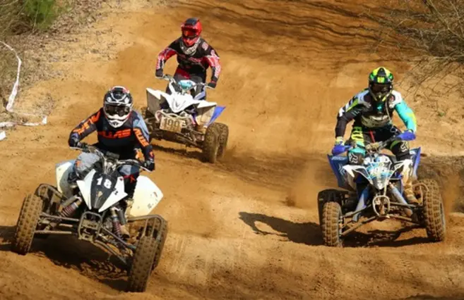 Three ATVs on a trail.